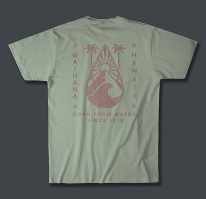 Back of a sage green Waihana Tropic Drop Premium Pima T-Shirt showing a distressed rose-pink graphic of palm trees, a surfboard, and ocean wave with 'Waihana Hawaii' and 'Born From Water Since 2018' text.