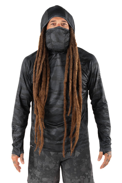 Male model with long dreadlocks wearing the Waihana Tropicam Black Sun Shirt with built-in hood and face gaiter, shown from the front against a white studio background.