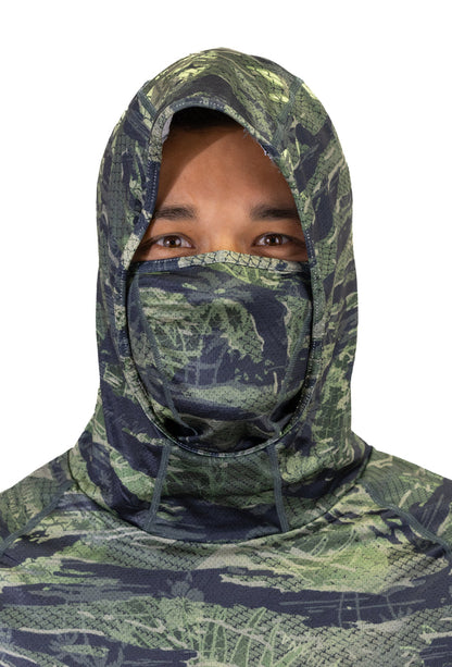 Male model wearing a Waihana Tropicam Sun Shirt with the full hood pulled up and integrated face mask covering the nose and mouth, showing the green camouflage pattern up close.