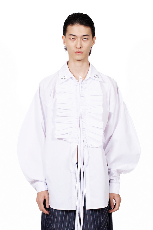 Vampire Ruffle Shirt in white cotton poplin with frayed ruffle placket, tie closures and oversized silhouette.