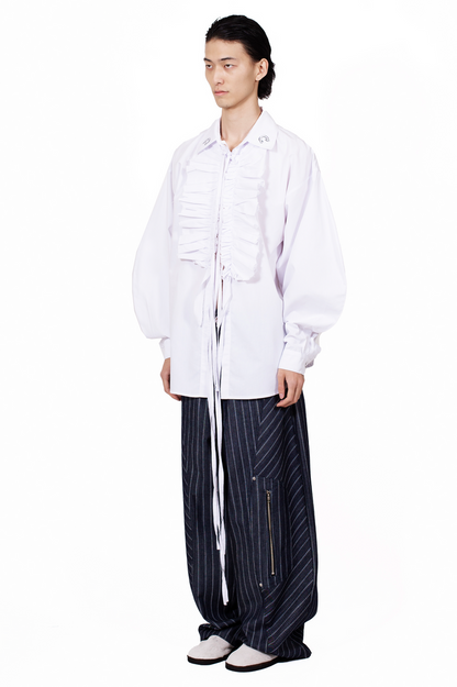 Vampire Ruffle Shirt in white cotton poplin with frayed ruffle placket, tie closures and oversized silhouette.