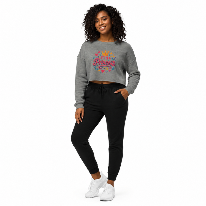 Close-up of women's cropped sweatshirt raw hem detail with ribbed cuff and collar accents on a soft cotton-poly blend fabric.