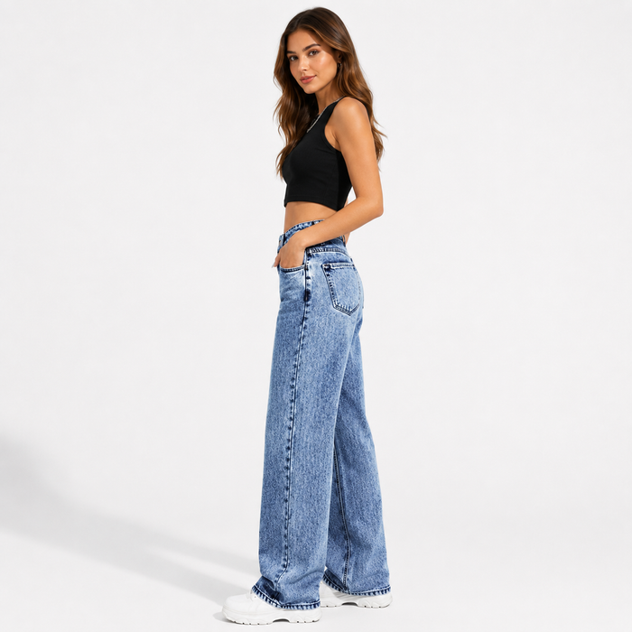 Women's high waisted wide leg jeans in medium blue wash, side view showing the long wide leg shape and denim seam detail.