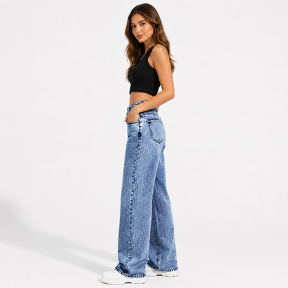 Women's high waisted wide leg jeans in medium blue wash, side view showing the long wide leg shape and denim seam detail.