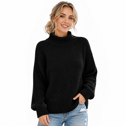 Women's black turtleneck sweater on model with textured knit, ribbed neckline, cuffs and hem on a clean white background.