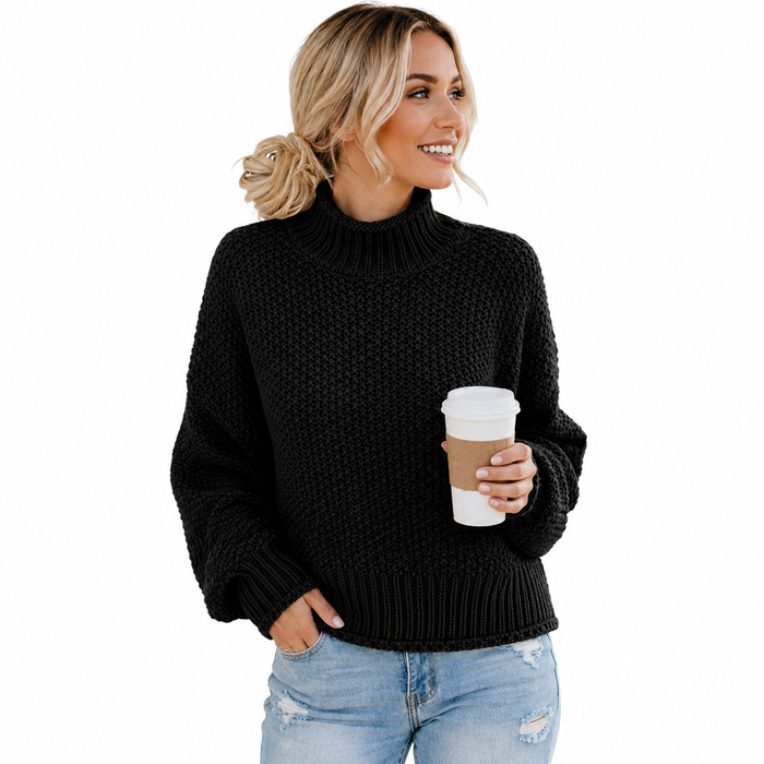 Women's black turtleneck sweater on a model holding a coffee cup, styled with jeans on a clean white studio background.